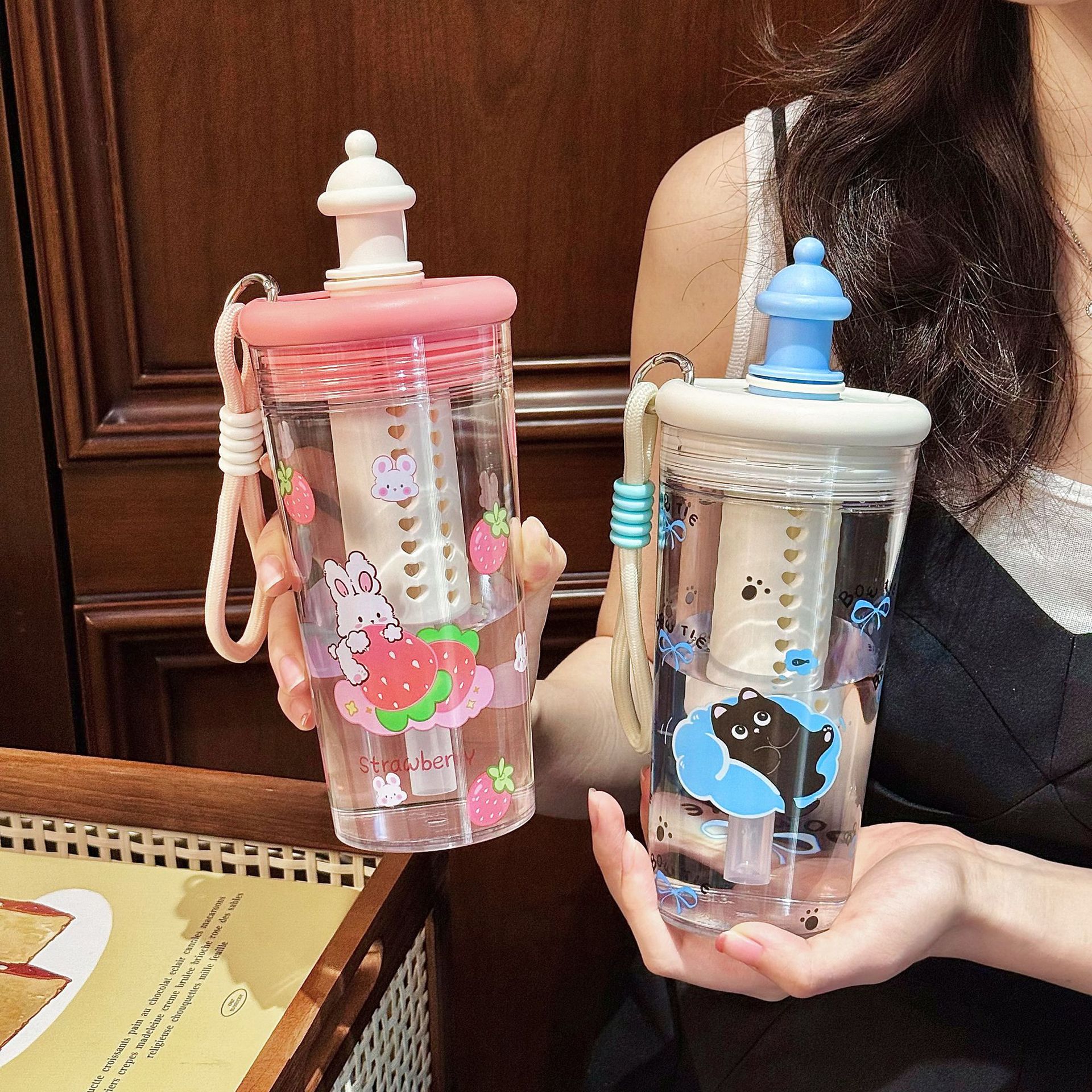 The new cute tritan water cup with a filter and straw is a portable cartoon student plastic cup with a high appearance level full figure