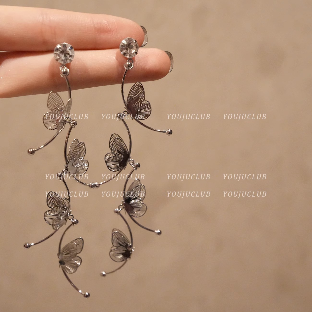 Long, ethereal, hollowed-out butterfly earrings with a light luxury, niche and high-end feel, tassel stud earrings, a versatile Korean-style ear accessory full figure