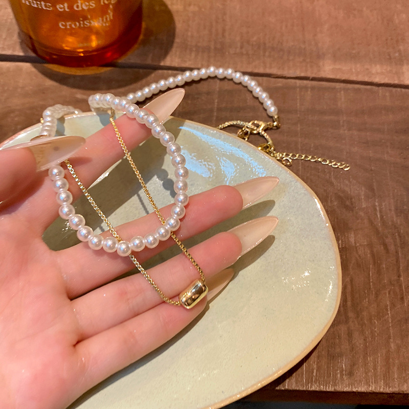 This Korean-style double-layered love bean imitation pearl necklace exudes a feminine and high-end charm and is versatile. The collarbone chain is a trendy accessory for a stylish look full figure