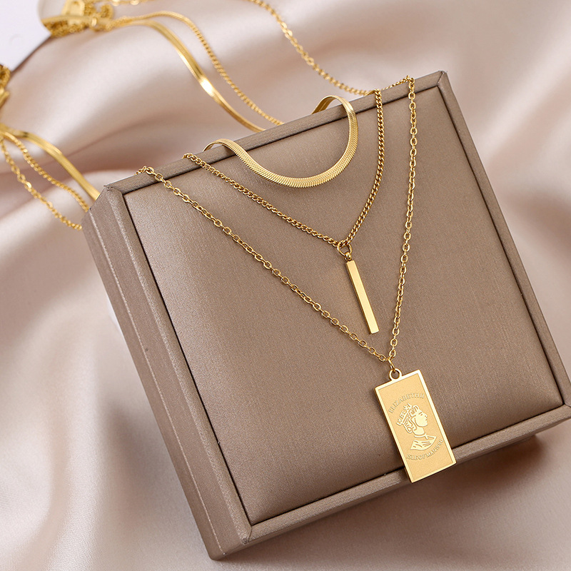 An irregular, simple and versatile titanium steel pendant necklace featuring a long and square queen's head in European and American fashion full figure