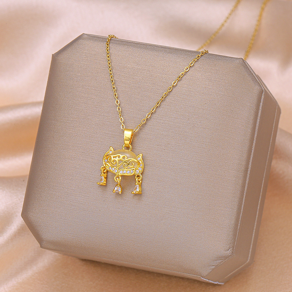 A high-end Japanese and Korean cat's eye stone fox-shaped safety lock pendant titanium steel necklace, a women's niche and light luxury tassel accessory full figure