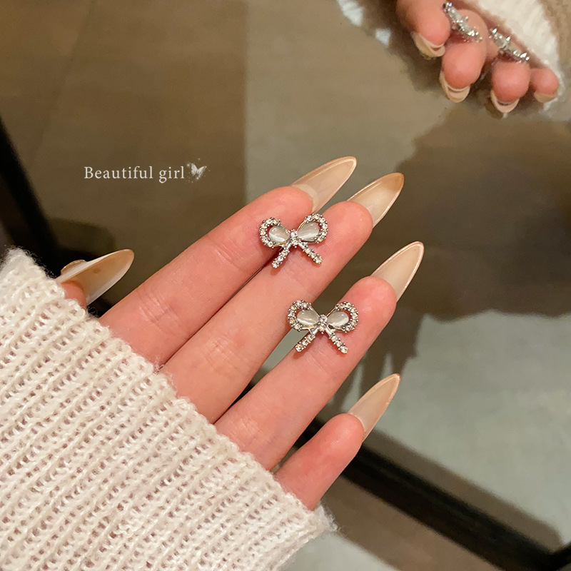 Zirconium-encrusted cat's eye stone bow earrings, women's light luxury, niche and high-end feel, small and exquisite ear studs, wholesale of internet-famous earrings full figure