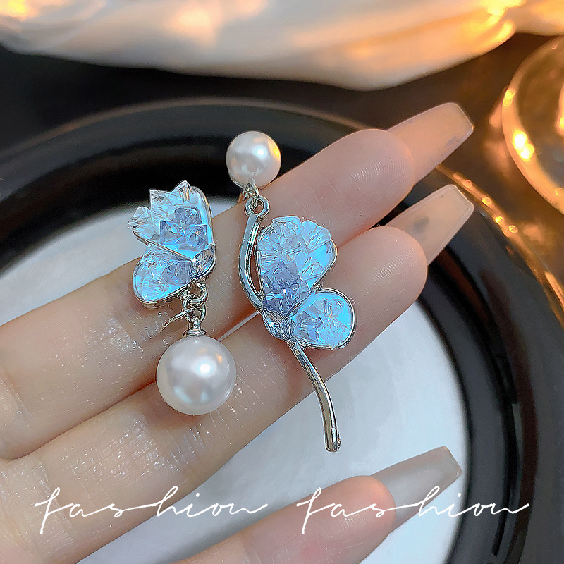 Asymmetrical milky blue ice crystal earrings exude a sense of sophistication, freshness and girlish charm. 925 silver needle earrings are trendy full figure