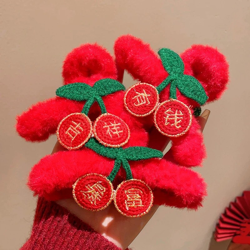 A red New Year plush hair clip on the back of a woman's head, symbolizing sudden wealth. It features a half-hair bun and a shark clip headpiece for the Year of the Snake details Picture