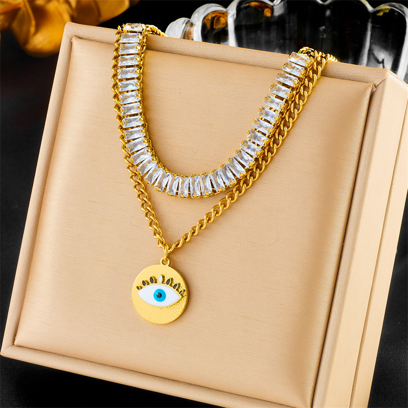 This is a unique and fashionable design from Europe and America. It features a double-layered chain with diamonds, a round eye pendant, and a titanium steel gold-plated necklace full figure