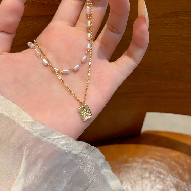Double-layer stacked millet grain pearl necklace, women's light luxury, niche and high-end collarbone chain, personalized neck chain accessory wholesale full figure