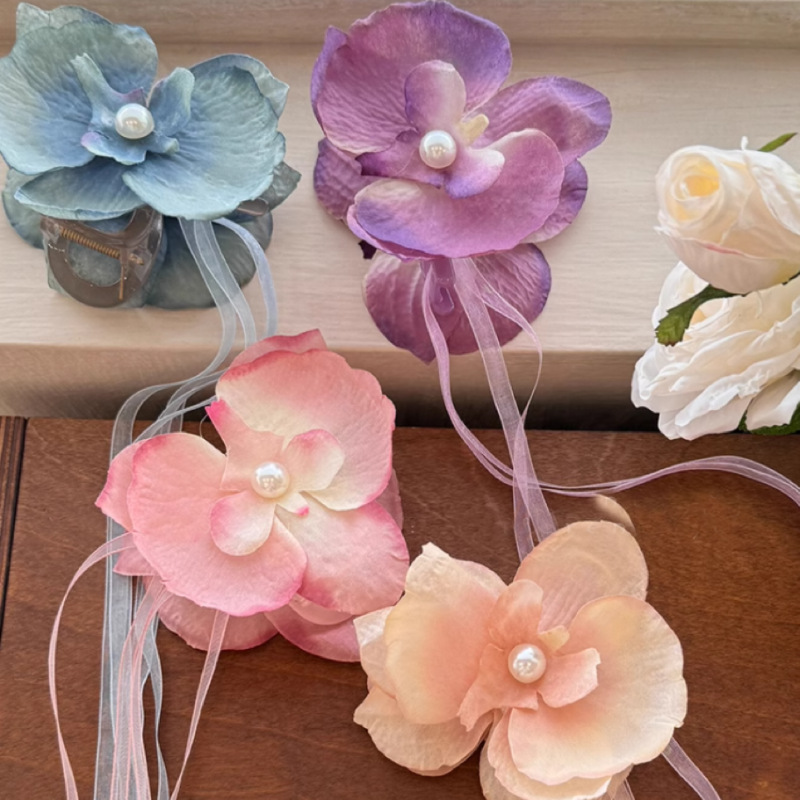 The super fairy-like Phalaenopsis flower ribbon hairpin for women's travel atmosphere, a new hair accessory for 2024 full figure