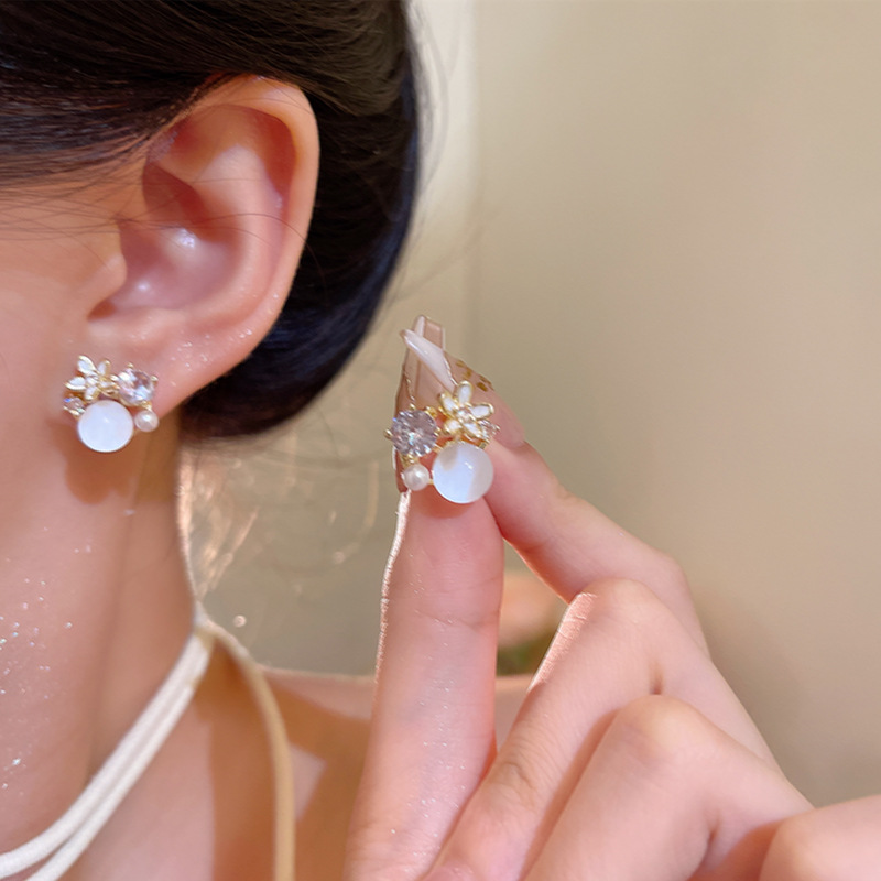 Micro-inlaid zircon pearl flower earrings, a light luxury and niche design for women, exude a sense of sophistication. Cat's eye stone ear studs, a stylish and trendy accessory details Picture
