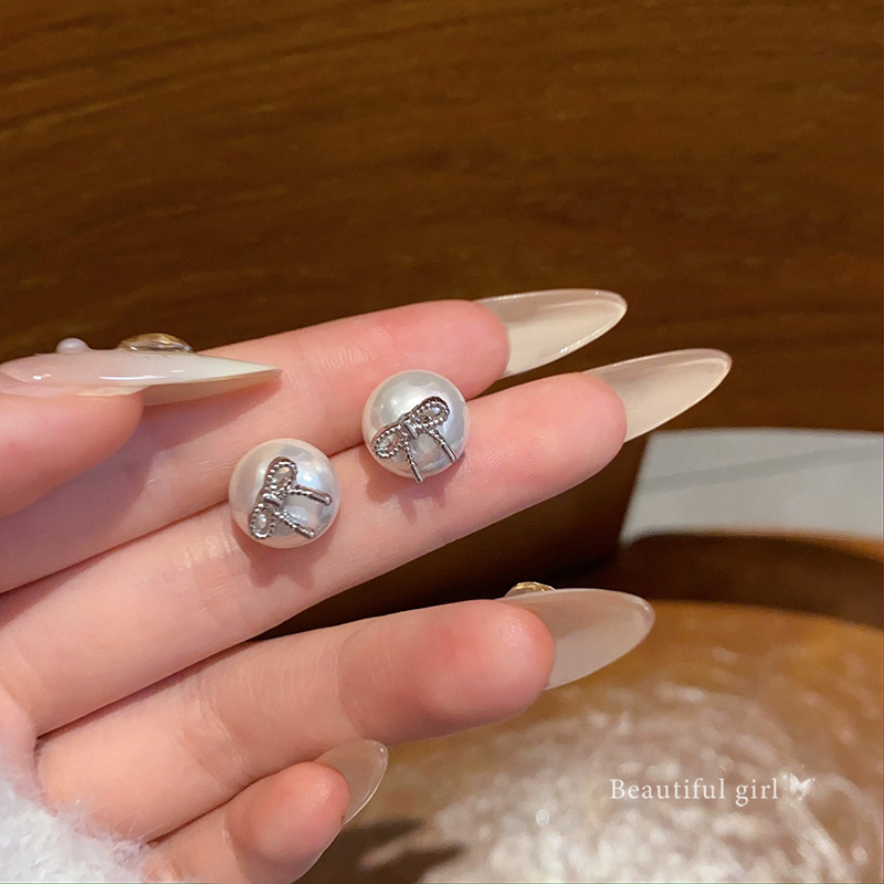 S925 Silver needle bow pearl Stud earrings for women, light luxury, versatile, elegant, high-end and grand autumn and winter earrings wholesale full figure