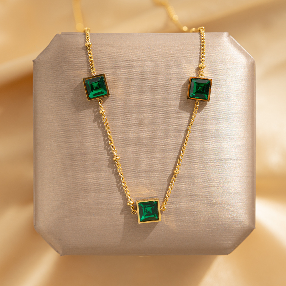 Doudou Chain, a luxurious titanium steel necklace with three green diamonds, exudes a fashionable and sophisticated feminine charm. It's a popular collarbone chain and a versatile accessory details Picture