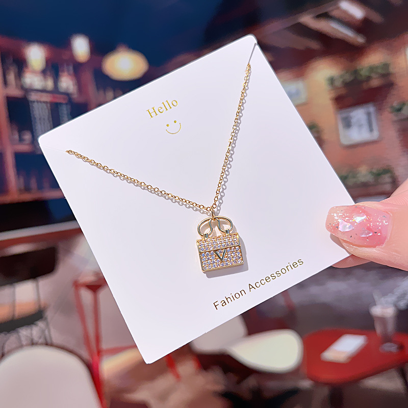 Genuine gold electroplated fashionable commuting V-shaped bag pendant, titanium steel necklace, women's light luxury, versatile, full diamond high-end collarbone chain Application Scenario