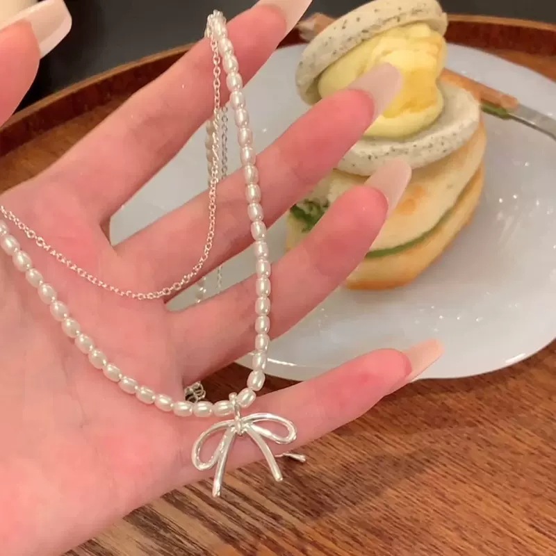 Korean-style double-layer pearl snake bone chain bow necklace, a trendy, versatile, light luxury and high-end collarbone chain accessory for women on Instagram details Picture