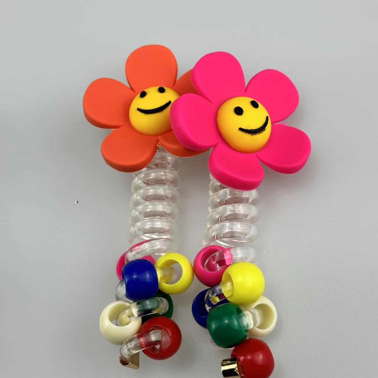 A girl's sunflower telephone line hair tie with a smiling face, a transparent ponytail braid, a hair braiding tool, and a beaded hair string accessory Application Scenario