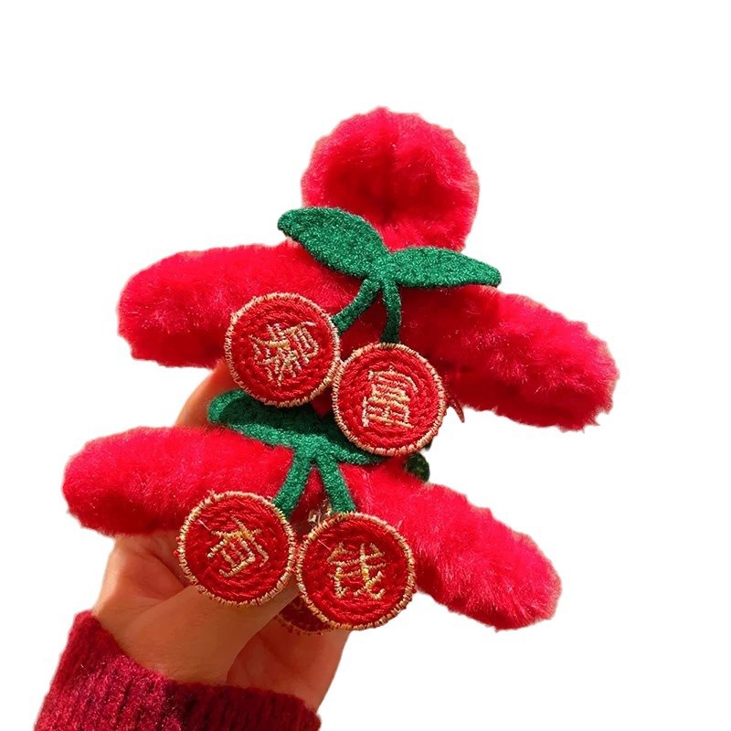 A red New Year plush hair clip on the back of a woman's head, symbolizing sudden wealth. It features a half-hair bun and a shark clip headpiece for the Year of the Snake Item Picture