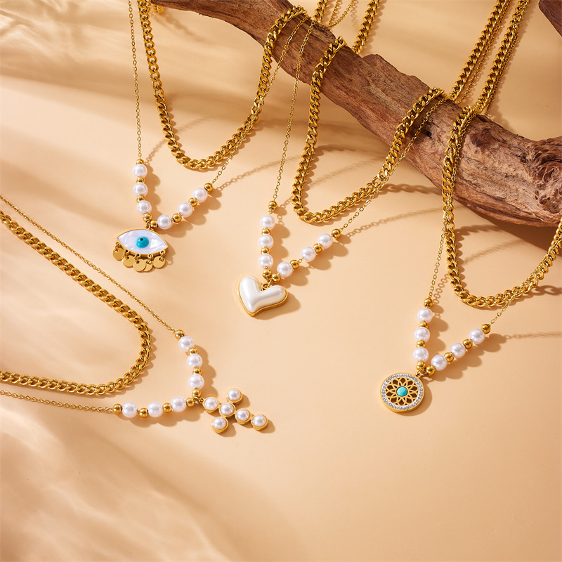 A retro necklace with European and American fashion style, inlaid with pearls, heart-shaped cross eyes, turquoise pendants and double-layer stainless steel full figure