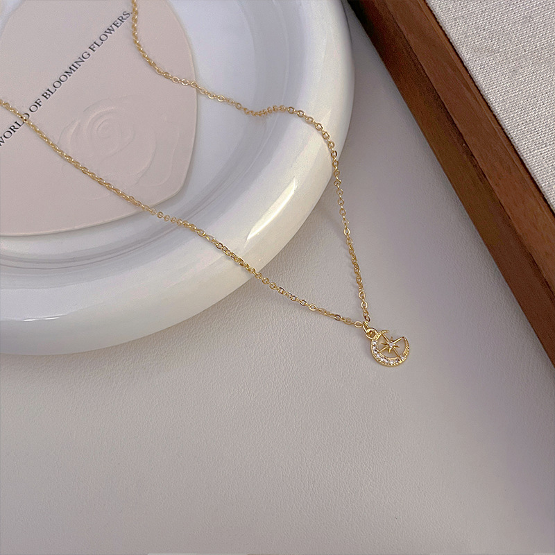 This is a unique and exquisite golden pendant necklace, a sweet star and moon zircon geometric new design with a sense of style and elegance details Picture