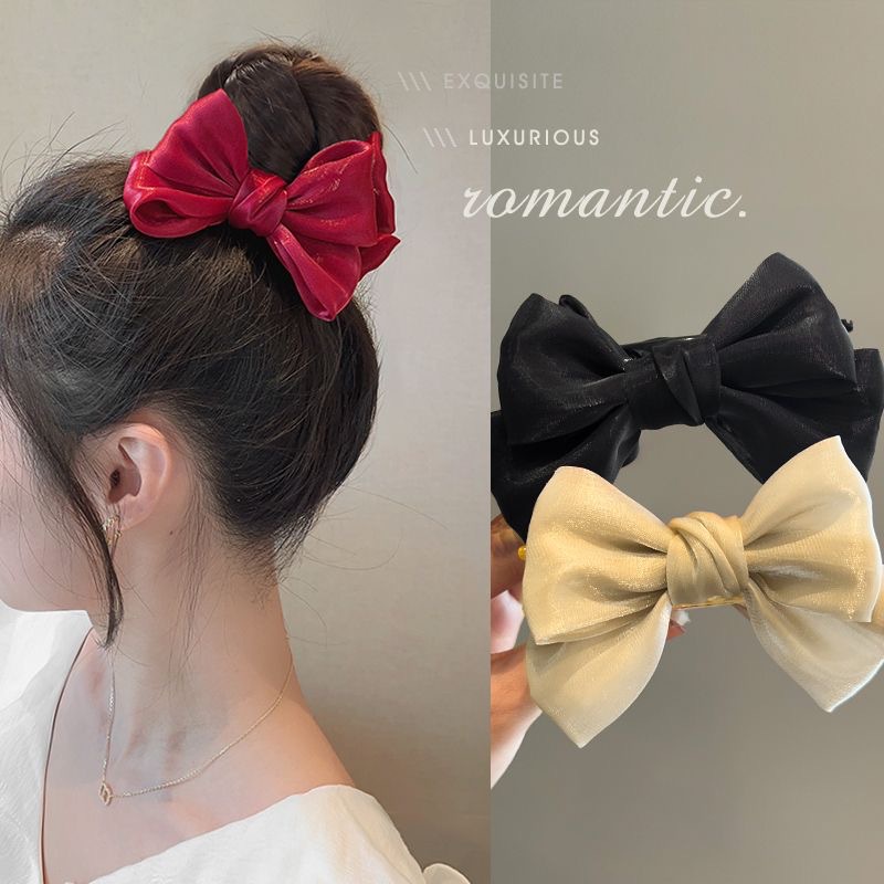 A cute red bow bun clip for a princess on the run, a popular hair accessory for both children and adults full figure