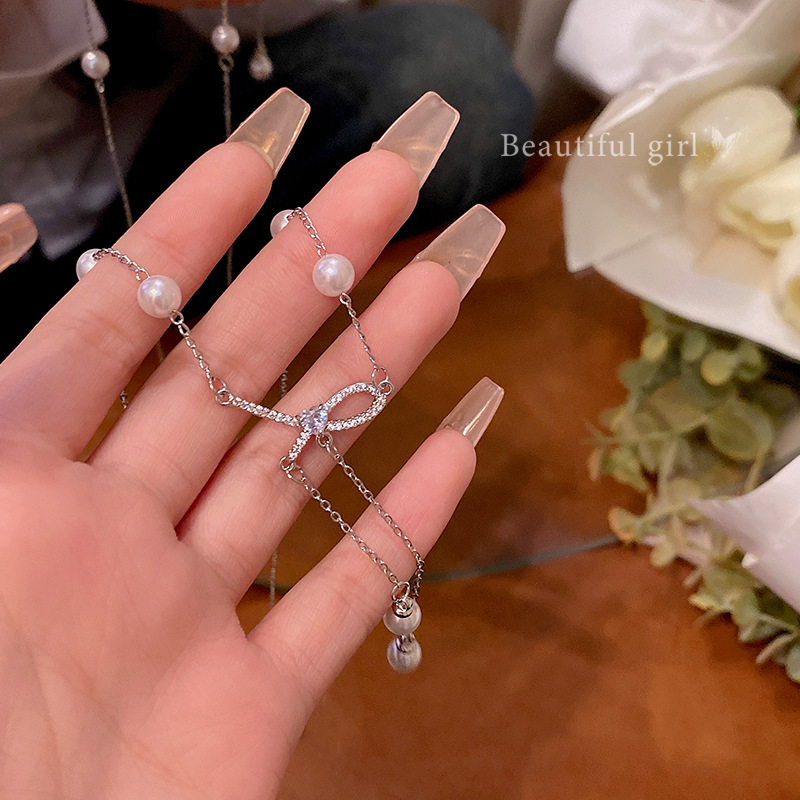 Bow pearl tassel necklace, women's light luxury, niche and high-end collarbone chain, neck chain accessory, autumn and winter sweater chain full figure