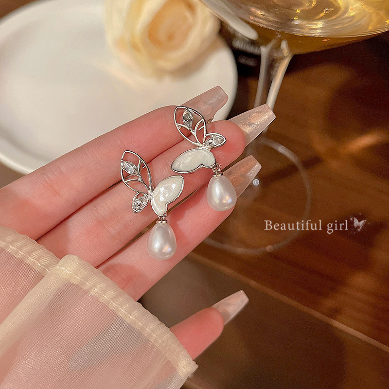 S925 Silver Needle hollowed-out crystal butterfly earrings are versatile for women, exuding a light luxury and high-end feel. Pearl stud earrings are elegant and sophisticated earrings for a socialite full figure