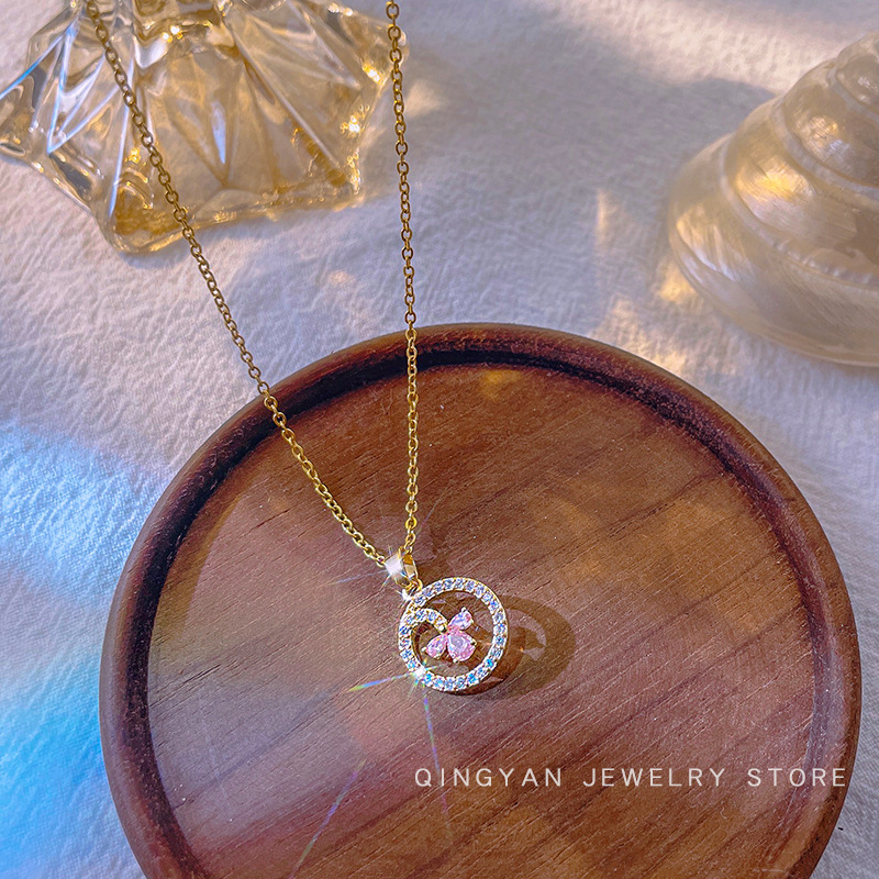 A high-end Japanese and Korean diamond-encruted round geometric titanium steel necklace with a unique and light luxury design for women, featuring an E-letter pendant accessory details Picture
