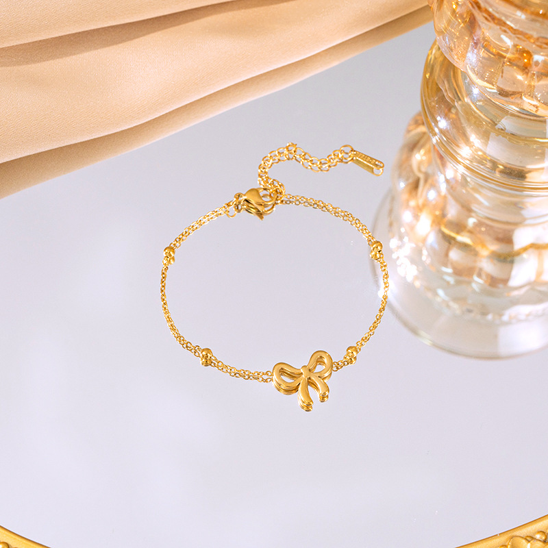 Titanium steel simple bean chain bow necklace, women's bracelet and stud three-piece set, non-fading, elegant and light luxury collarbone chain Application Scenario