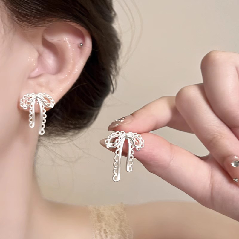Ballet-style bow stud earrings, matte silver hollowed-out niche design ribbon earrings, delicate and sweet earrings for women details Picture