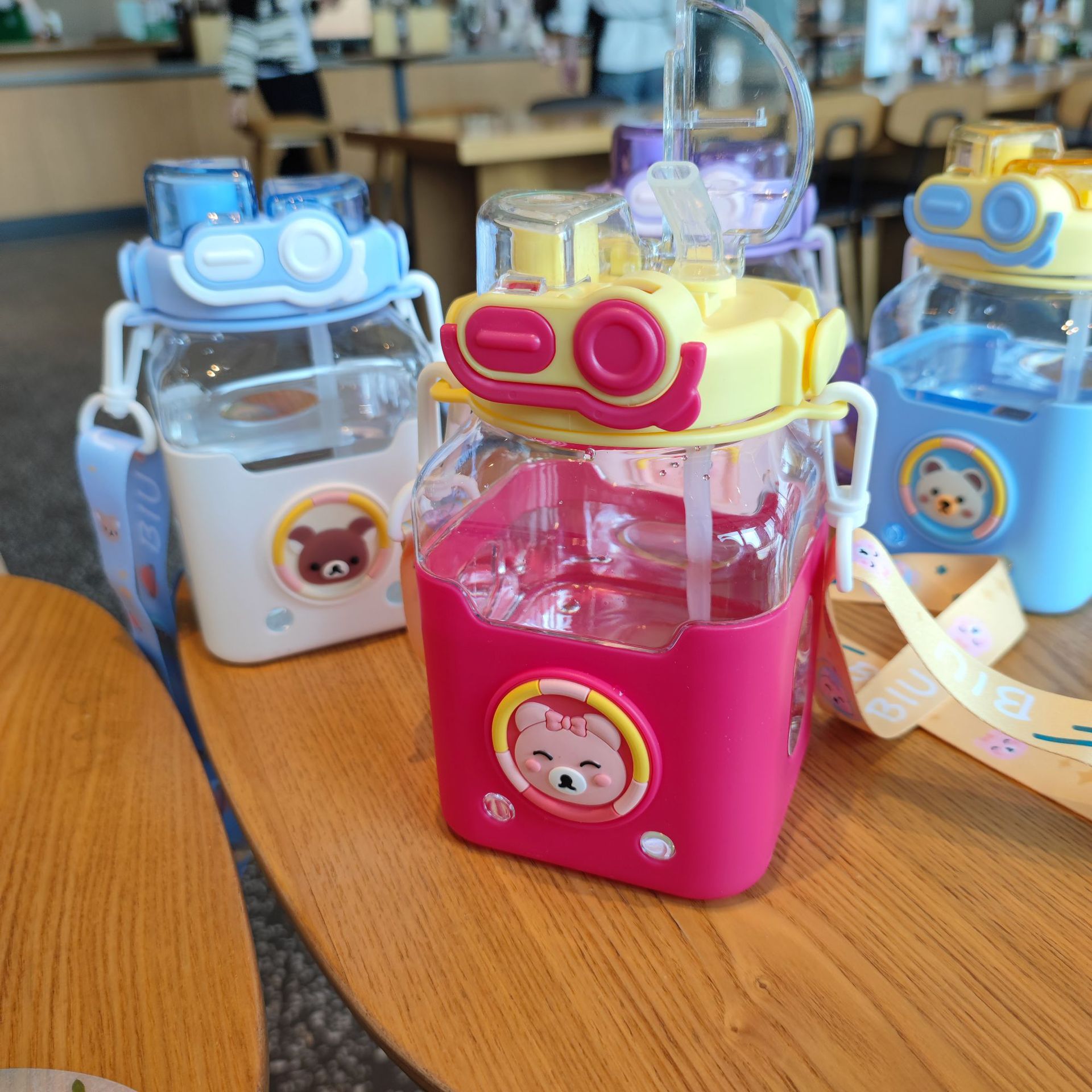 Large-capacity wholesale, cute cartoon children's new square straw cup, portable strap, high appearance level student water bottle Application Scenario