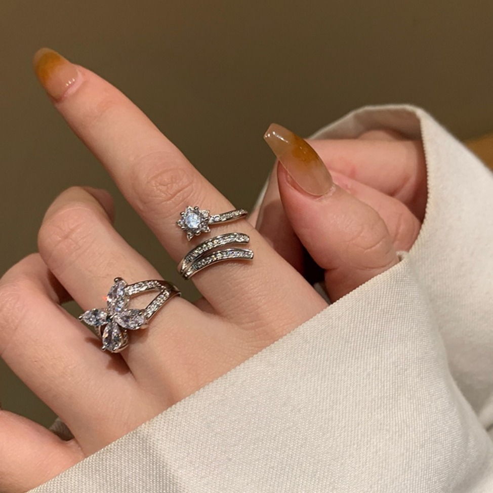 A niche design of a star-shaped butterfly zirconia open ring for women, exuding a sense of light luxury and sophistication, with a fashionable and individualistic vibe full figure