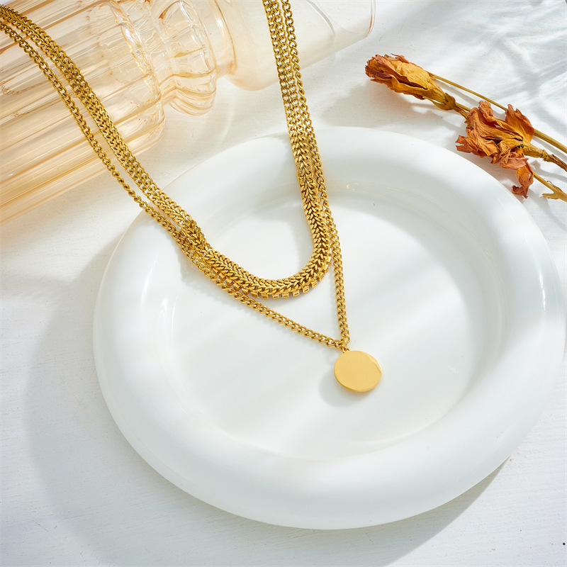 This is a unique and fashionable design from Europe and America. It features a double-layered chain with diamonds, a round eye pendant, and a titanium steel gold-plated necklace details Picture
