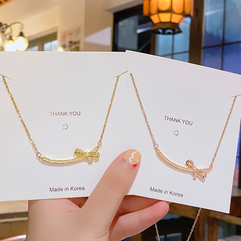 Elegant and luxurious, full diamond zircon smiling bow necklace, a niche design for women with a sense of high-end titanium steel collarbone chain wholesale Specification drawing