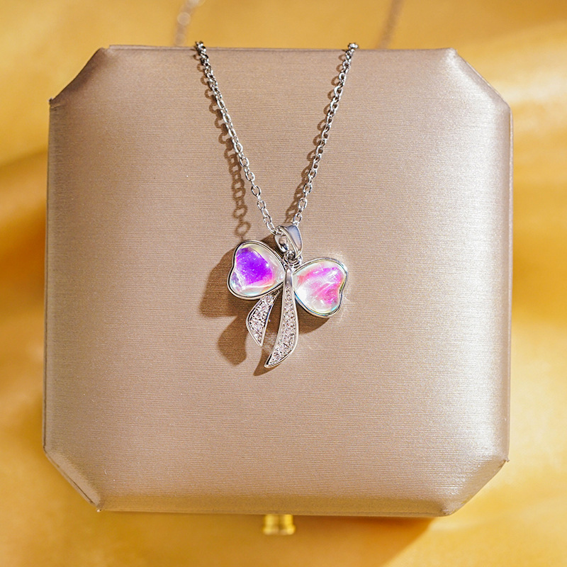 The dazzling color-changing bow necklace features a unique and light luxury design for women. The versatile pearl collarbone chain exudes a trendy and high-end style details Picture