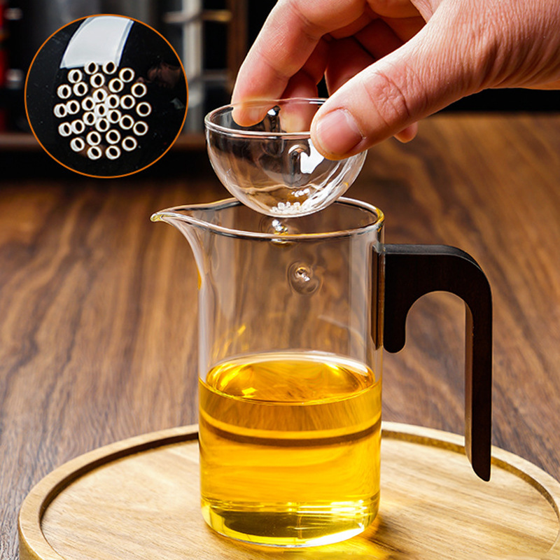 Wholesale thickened heat-resistant glass fair cup, integrated tea strout, tea water separation, tea brewing cup, small green tangerine rotating glass cup details Picture