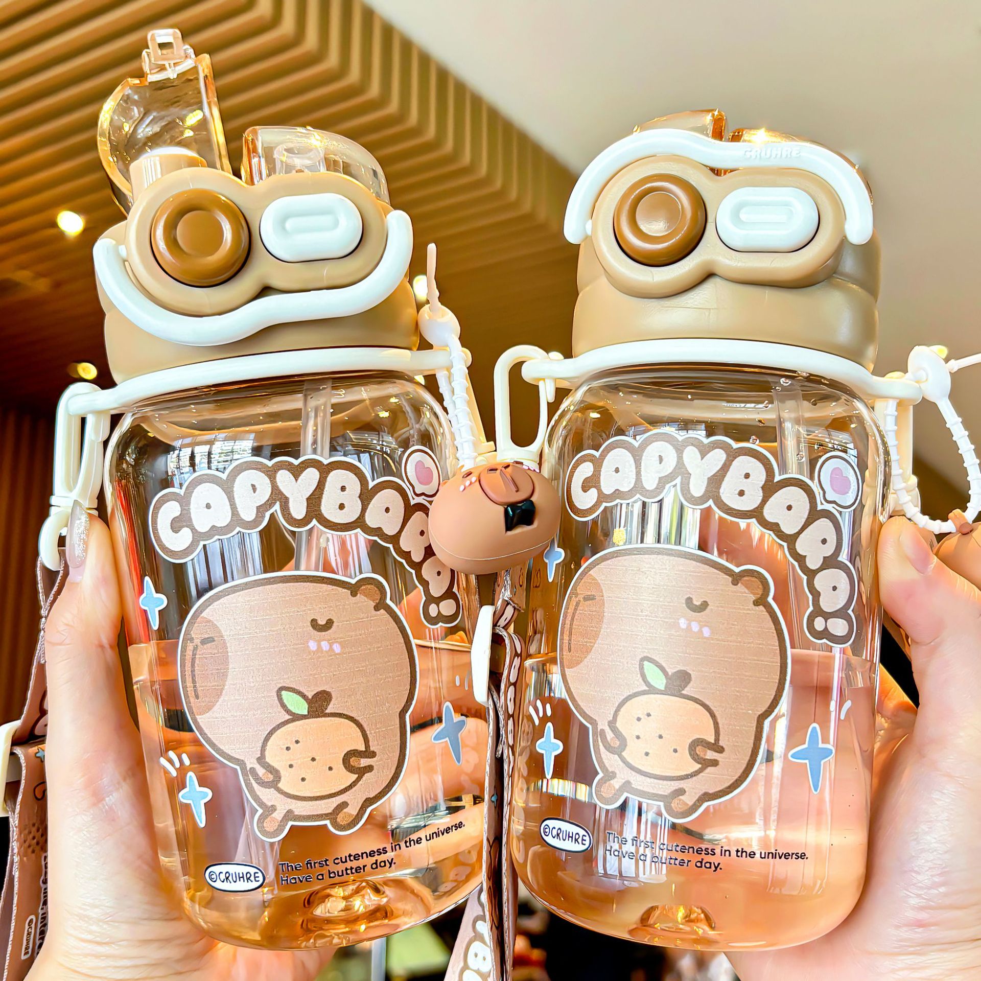 The 2025 new Capibara children's water cup is a cute, large-capacity, double-drinking cup with a lock, convenient handle and straw full figure