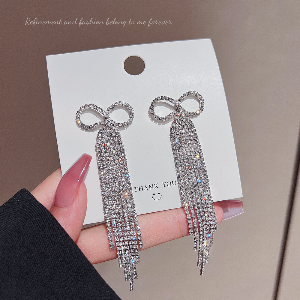 The 2025 new trendy Korean full-diamond bow long tassel earrings are a high-end and stylish light luxury accessory for female Internet celebrities full figure