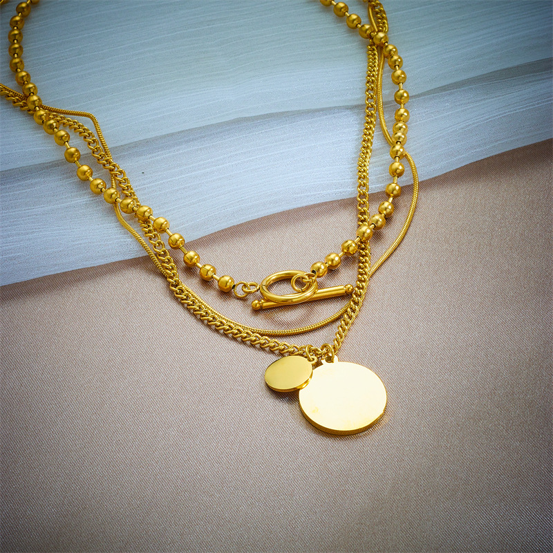A cross-border retro multi-layer pendant with a round tag and a woman's head, OT clasp, titanium steel metal, light luxury and niche necklace Application Scenario