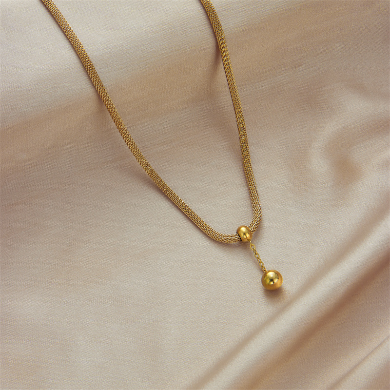 Korean version fashionable, elegant, high-end and niche design, hollowed-out cylindrical chain, gold bead tassel pendant, titanium steel jewelry necklace details Picture