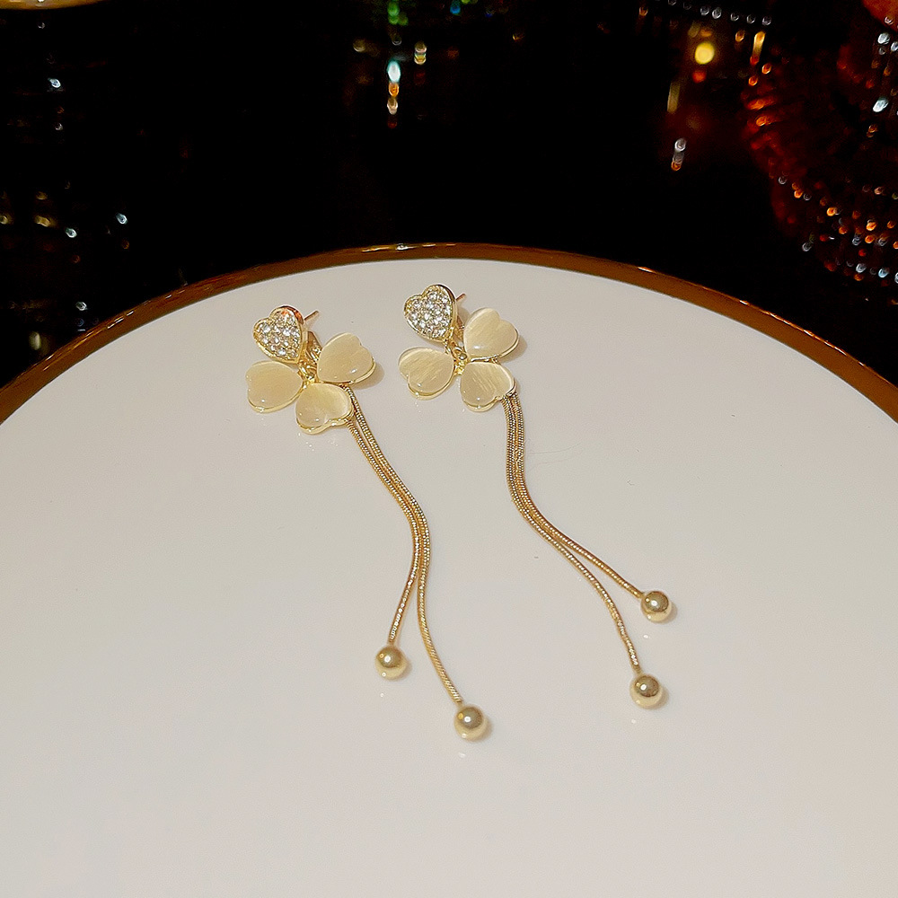 Elegant long cat's eye stone petal earrings for women, high-end and versatile ear studs for autumn and winter, light luxury and stylish Suzhou earrings wholesale Application Scenario