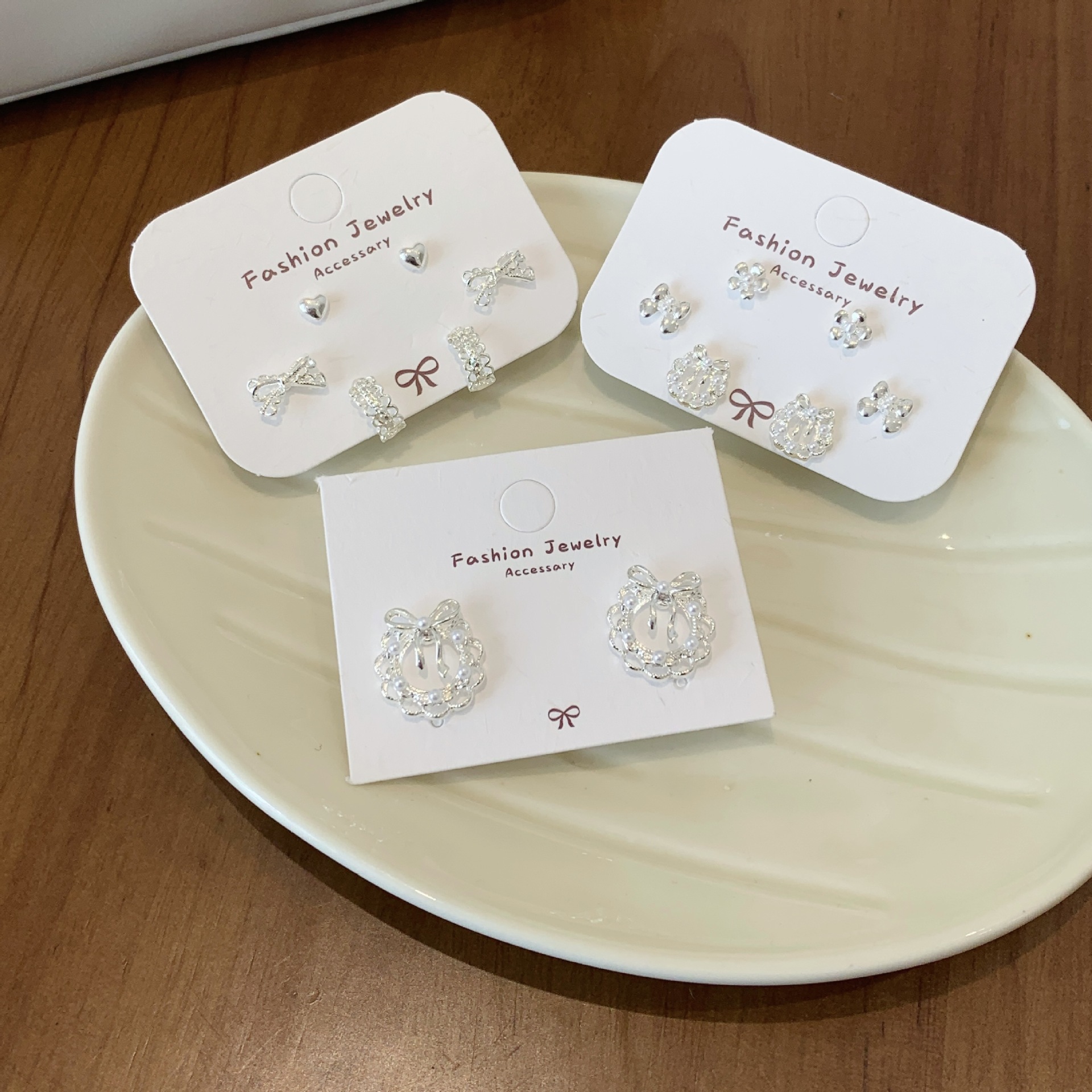 A three-piece set of Korean-style plain silver lace bow garland earrings with silver needles, featuring a fresh, niche and light luxury design Application Scenario