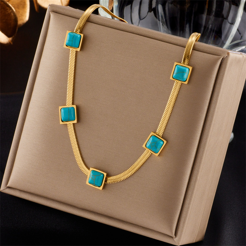 A new cross-border fashion collarbone necklace with a unique design of gold and silver dual-color titanium steel snake bone chain and turquoise cubes full figure