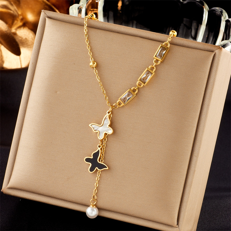 A high-end and light luxury titanium steel collarbone chain featuring a new European and American shell black and white butterfly square zircon tassel necklace full figure