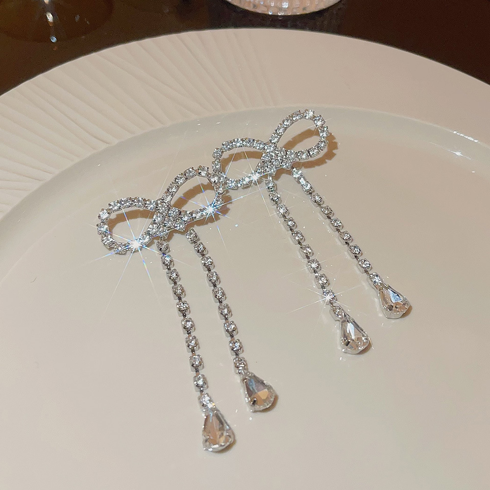 The new Korean-style exaggerated bow earrings exude a niche and high-end vibe, with a cold and simple long full-diamond earrings for women details Picture
