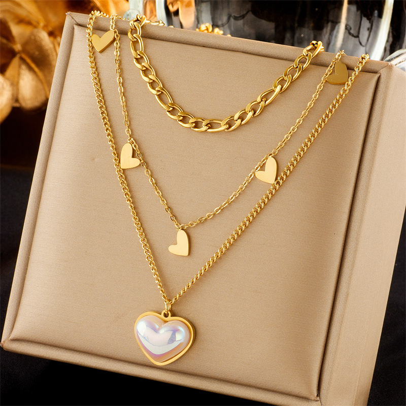 This is a versatile necklace featuring a unique and fashionable design of titanium and steel multi-layer mixed chain with a pearl and heart-shaped pendant full figure