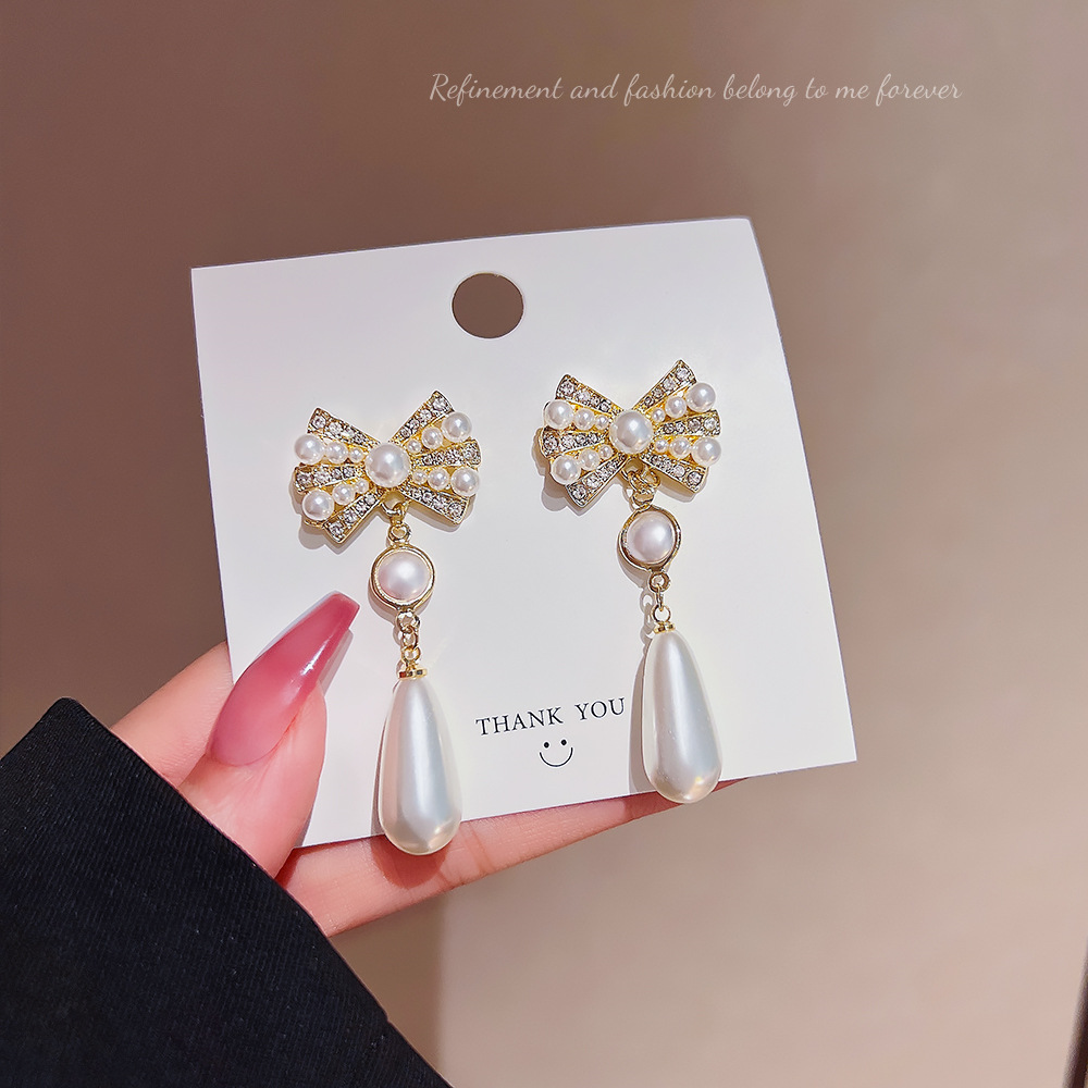 Long tassel pearl earrings, fashionable and elegant lady style, light luxury bow earrings, silver needle high-end earrings, women's wholesale full figure
