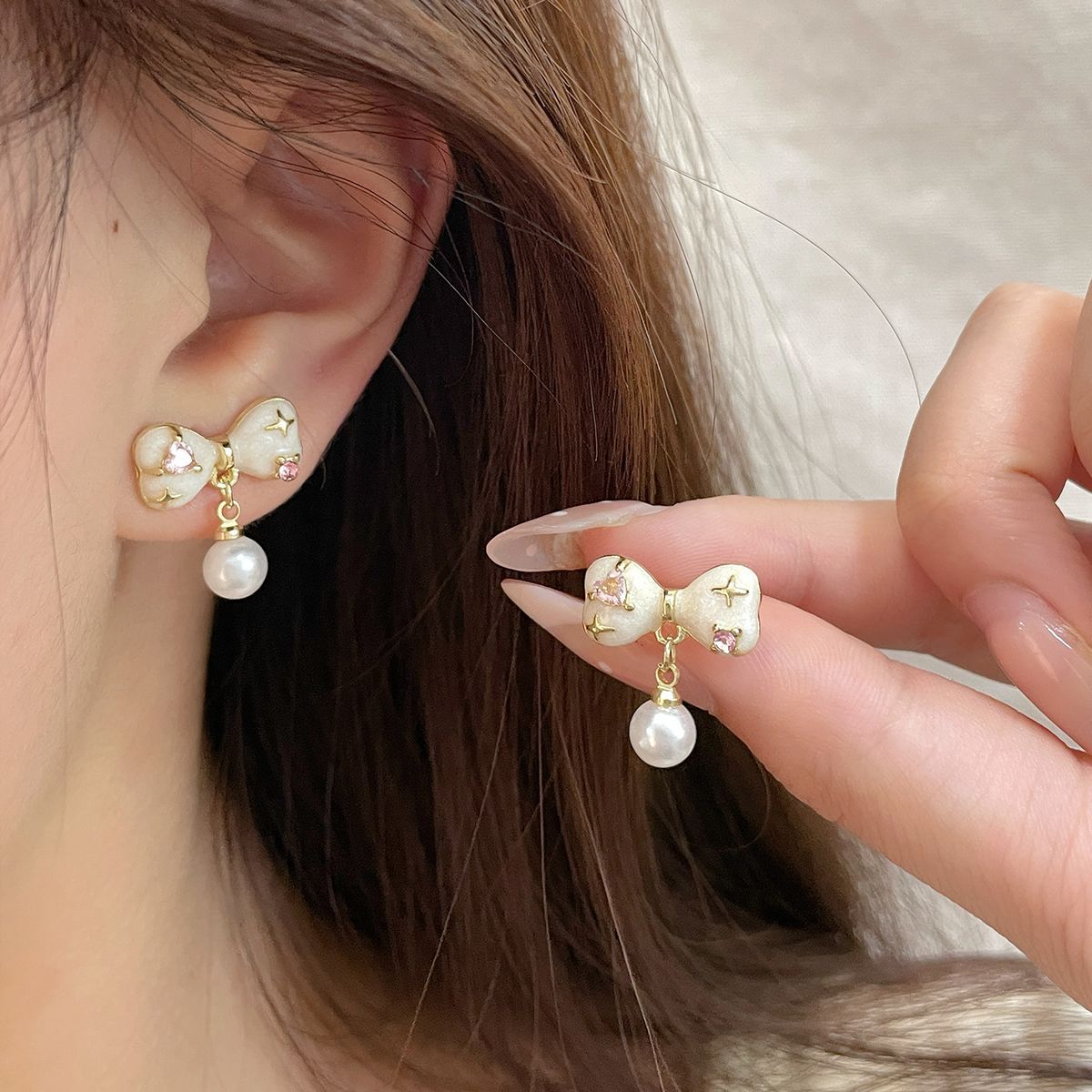 Korean style unique pink zircon oil drip bow earrings, women's silver needle pearl tassel pendant, versatile and sweet earrings details Picture