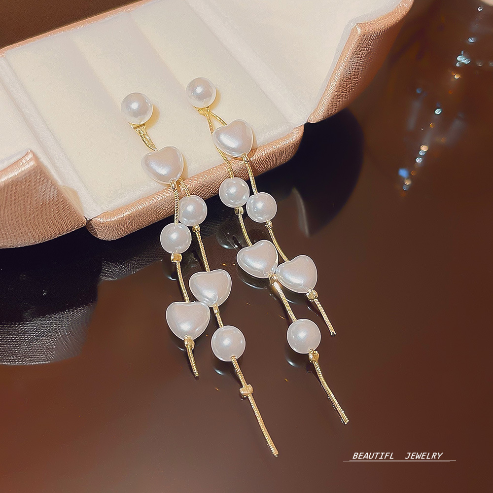 Luxurious heart-shaped pearl tassel earrings for socialites, with a unique design sense, versatile and exquisite earrings, and a high-end feel. Super fairy-like earrings full figure