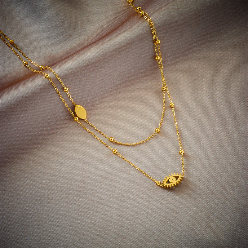 A double-layer mixed chain necklace with gold beads, titanium steel, oil-dripping and hollowed-out blue eyes, featuring a niche and fashionable design from Europe and America details Picture