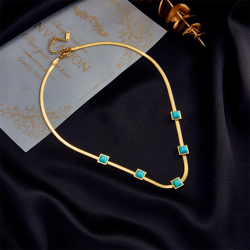 A new cross-border fashion collarbone necklace with a unique design of gold and silver dual-color titanium steel snake bone chain and turquoise cubes details Picture