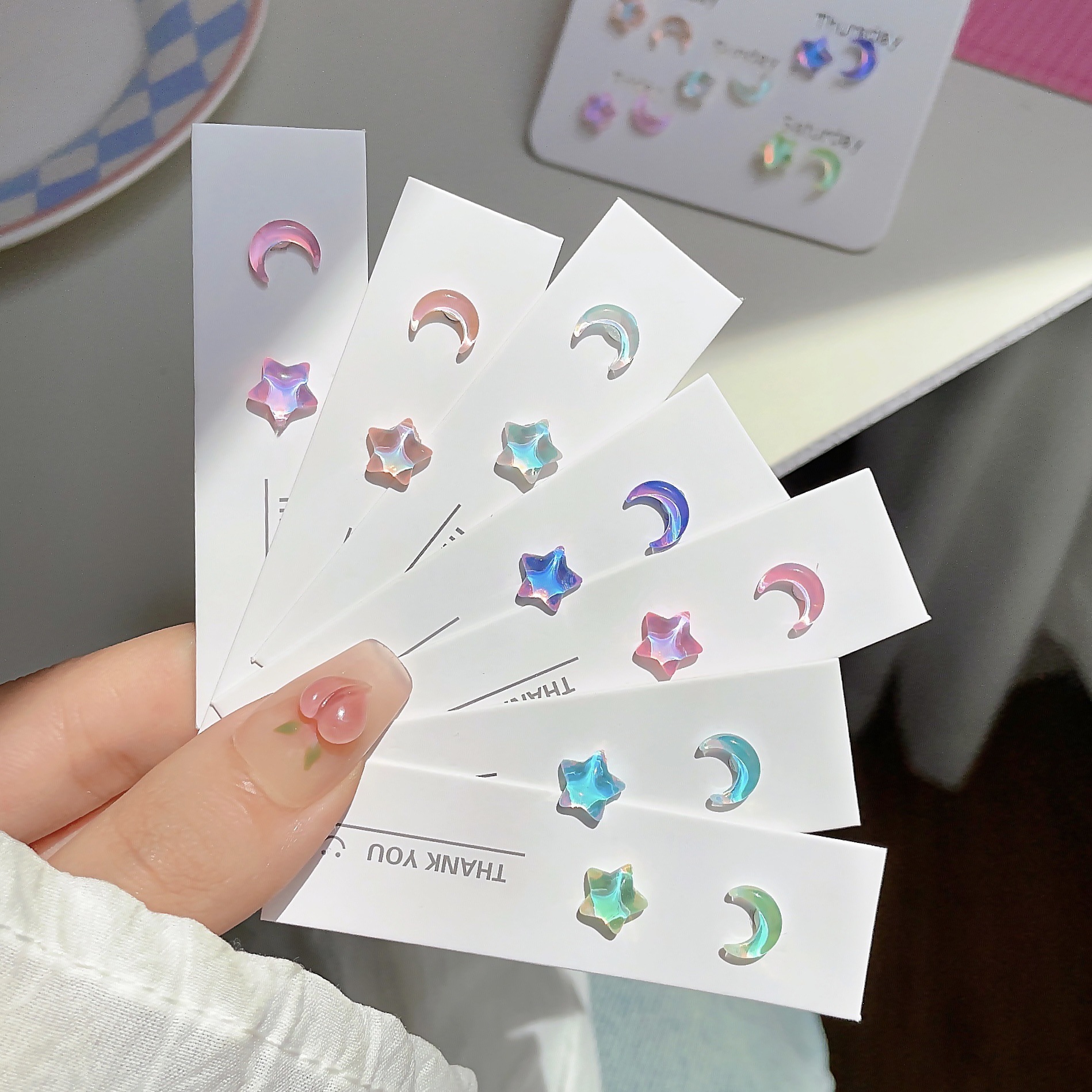 The fresh and delicate silver needle Mocha Star Moon girl ear studs are sweet, small, clear, super shiny and versatile ear piercing earrings details Picture