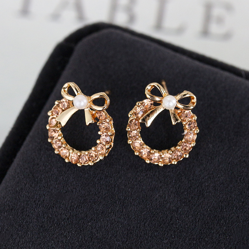 European and American inS-style pearl bow stud earrings, women's unique and elegant style, studded with colorful diamonds, hollowed-out round earrings, cross-border earrings full figure