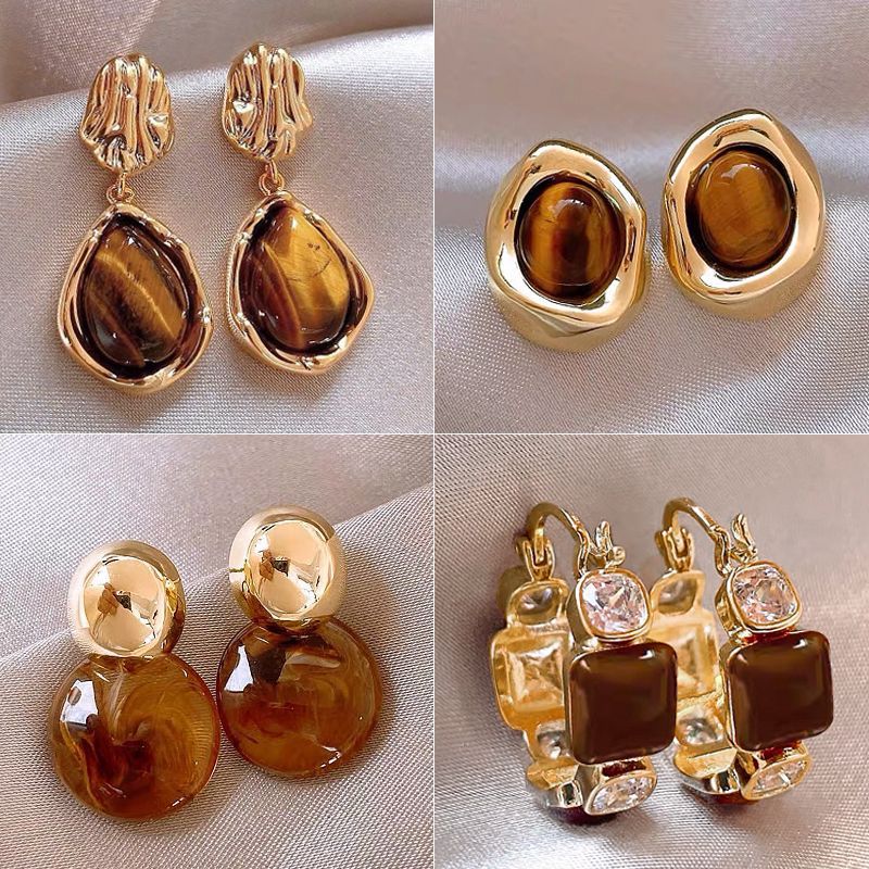 Hong Kong-style unique tiger's eye stone earrings, retro Maillard earrings, women's niche design sense, high-end stud earrings, light luxury, versatile full figure